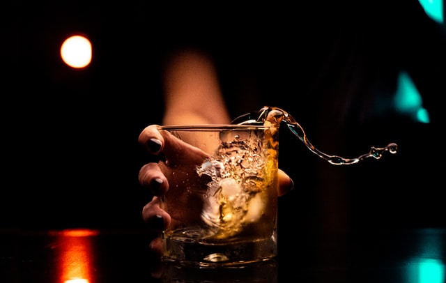 A woman holding a glass of wine in her hands